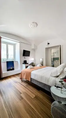 a bedroom with a large bed and a table at Giorgina Garden&Rooms in Rome