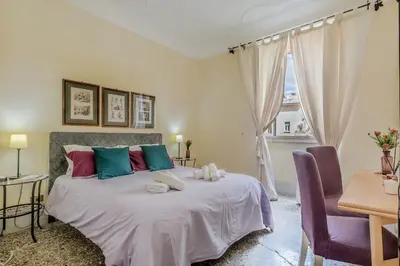 a bedroom with a large bed with colorful pillows at Vatican House intero appartamento in Rome