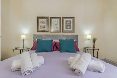 a bedroom with a large bed with towels on it at Vatican House intero appartamento in Rome