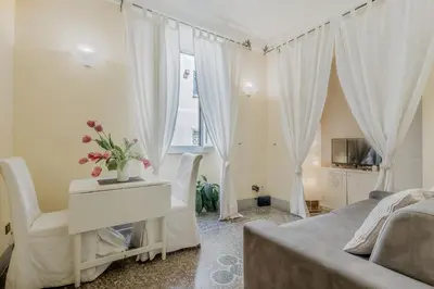 a bedroom with a bed and a table with flowers on it at Vatican House intero appartamento in Rome