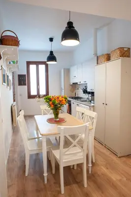 a kitchen and dining room with a table and chairs at Casa Luce 66 in Rome