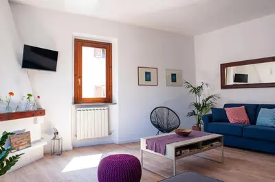 a living room with a blue couch and a table at Casa Luce 66 in Rome