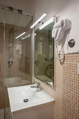 a bathroom with a sink and a phone on the wall at Casa Luce 66 in Rome