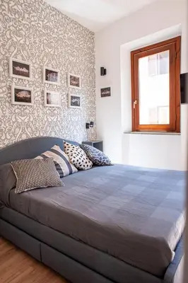 a bedroom with a large bed with pillows on it at Casa Luce 66 in Rome