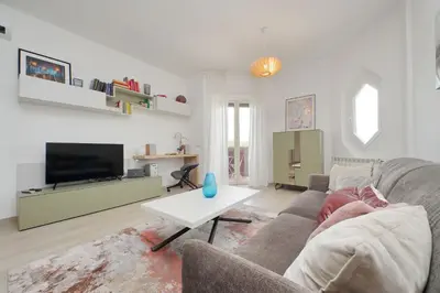 a living room with a couch and a table at YCH-Rifugio incantato sul Tevere in Rome