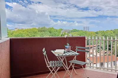 a balcony with a table and chairs on a balcony at YCH-Rifugio incantato sul Tevere in Rome