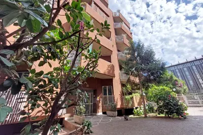 a building with a fence and a tree in front of it at YCH-Rifugio incantato sul Tevere in Rome