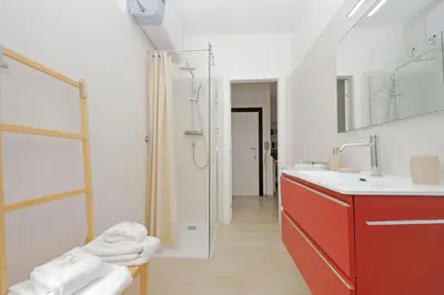 a bathroom with a red sink and a shower at YCH-Rifugio incantato sul Tevere in Rome