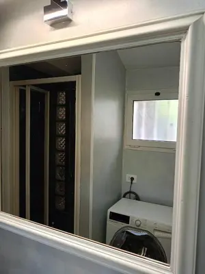 a mirror in a room with a washing machine at DELIGHTFUL LOFT IN PlGNETO in Rome