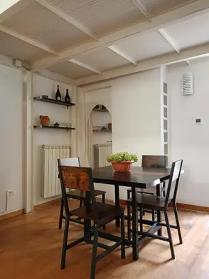 a dining room with a table and chairs at DELIGHTFUL LOFT IN PlGNETO in Rome
