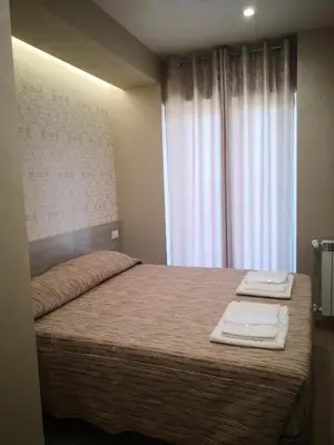 a bedroom with a bed with two towels on it at Gidà Room Metro B Monti Tiburtini Roma in Rome