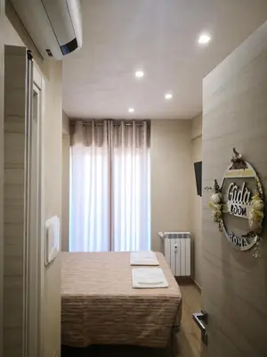 a small room with a bed with a window at Gidà Room Metro B Monti Tiburtini Roma in Rome