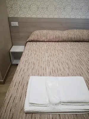 two beds in a room with a white tray on it at Gidà Room Metro B Monti Tiburtini Roma in Rome