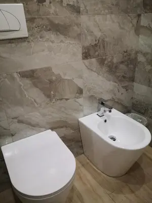 a bathroom with a white toilet and a sink at Gidà Room Metro B Monti Tiburtini Roma in Rome