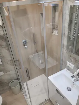 a bathroom with a shower and a sink at Gidà Room Metro B Monti Tiburtini Roma in Rome