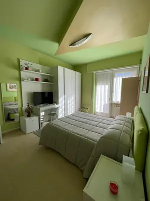 a bedroom with a large bed and a couch at Alloggio di Raffaello L in Rome
