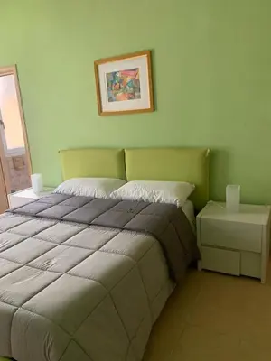 a bedroom with a bed and a picture on the wall at Alloggio di Raffaello L in Rome
