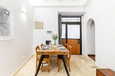 a dining room with a wooden table and chairs at Bottega Augustea Duplex apartment in Monti in Rome