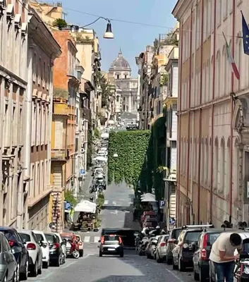 a city street with cars parked on the side of the road at Bottega Augustea Duplex apartment in Monti in Rome