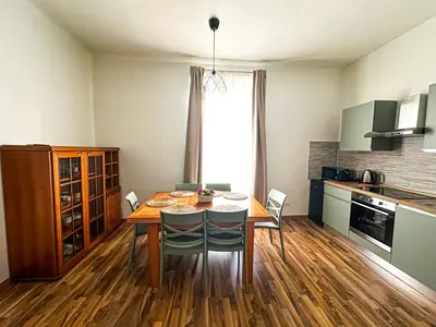 a kitchen with a dining room table with chairs and a tableablish at Giulio Cesare 237 in Rome