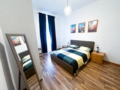 a bedroom with a bed and a mirror in it at Giulio Cesare 237 in Rome