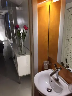 a bathroom with a sink and a vase of roses at Space Home in Rome
