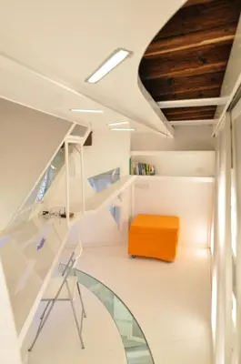 a room with a staircase and an orange stool at Space Home in Rome