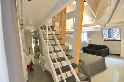a staircase leading up to a loft bed in a room at Space Home in Rome