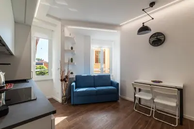 a living room with a blue couch and a table at GuestHost - Monteverde Classy Apartment in Rome