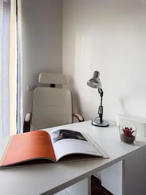 an open book on a desk with a lamp at Trastevere Station House in Rome