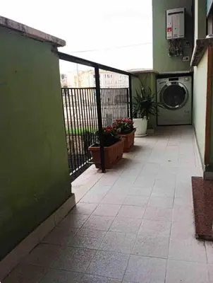 a balcony with a washing machine in a building at Trastevere Station House in Rome