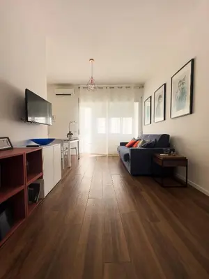 a living room with a couch and a table at Trastevere Station House in Rome