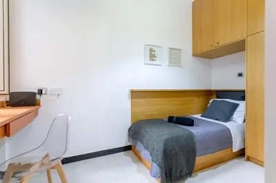 a bedroom with a bed and a desk and a chair at Mustard Apartment S Camillo - Holiday Homes Rome in Rome