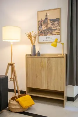 a living room with a lamp and a cabinet at Mustard Apartment S Camillo - Holiday Homes Rome in Rome
