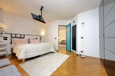 a bedroom with a bed and a room with a mirror at Vatican Luxury Apt with Garden in Rome
