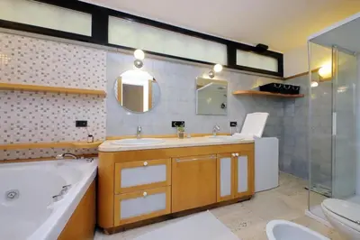 a bathroom with a sink and a tub and a toilet at Vatican Luxury Apt with Garden in Rome