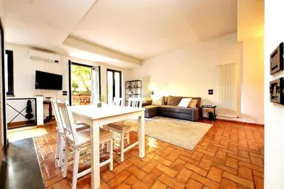 a living room with a table and chairs and a couch at Vatican Luxury Apt with Garden in Rome
