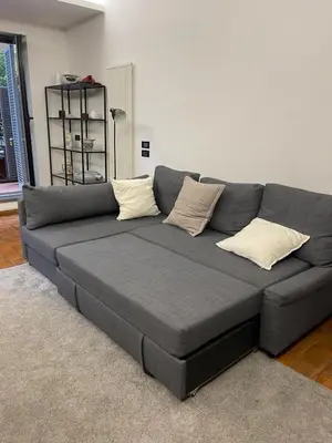 a gray couch in a living room with pillows at Vatican Luxury Apt with Garden in Rome