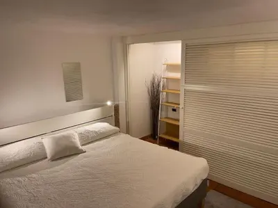 a bedroom with a white bed and a window at Vatican Luxury Apt with Garden in Rome