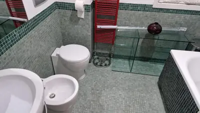 a bedroom with a dresser and a mirror and a chair at Via Tiburtina vicino Università e Stazione intero appartamento per la tua vacanza a Roma in Rome