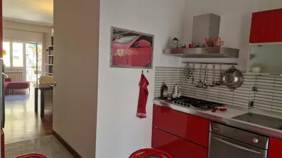 a kitchen with a glass table and a clock on the wall at Via Tiburtina vicino Università e Stazione intero appartamento per la tua vacanza a Roma in Rome