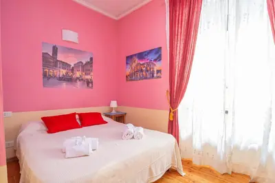 a bedroom with a bed with two towels on it at Vatican Rooms Haven in Rome