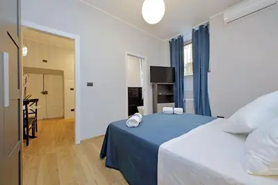 a bedroom with a bed with a blue blanket at Ostiense upsidedown in Rome