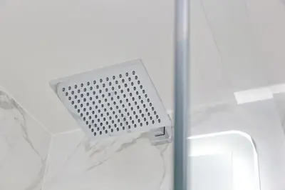 a metal object is sticking out of a shower door at Ostiense upsidedown in Rome