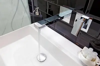 a bathroom counter with a sink with a faucet at Ostiense upsidedown in Rome