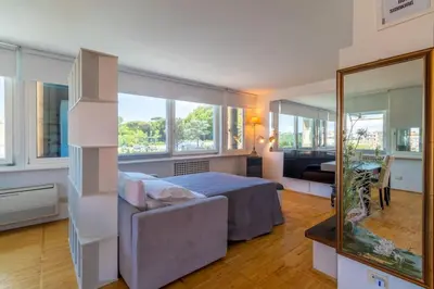a bedroom with a bed and a mirror at Imperial Rome Accommodation terrazza sul vaticano in Rome
