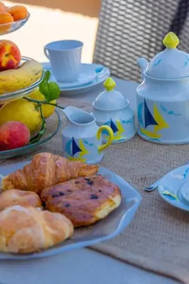 a table with plates of pastries and teapots at Imperial Rome Accommodation terrazza sul vaticano in Rome