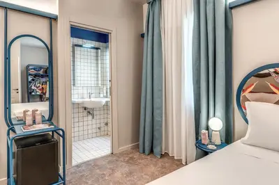 a bedroom with a bed and a bathroom at Hotel XX Settembre in Rome