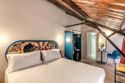 a bedroom with a large white bed in a room at Hotel XX Settembre in Rome