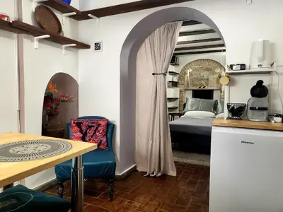 a bedroom with a bed and a table and chairs at Antica Trasteverina in Rome